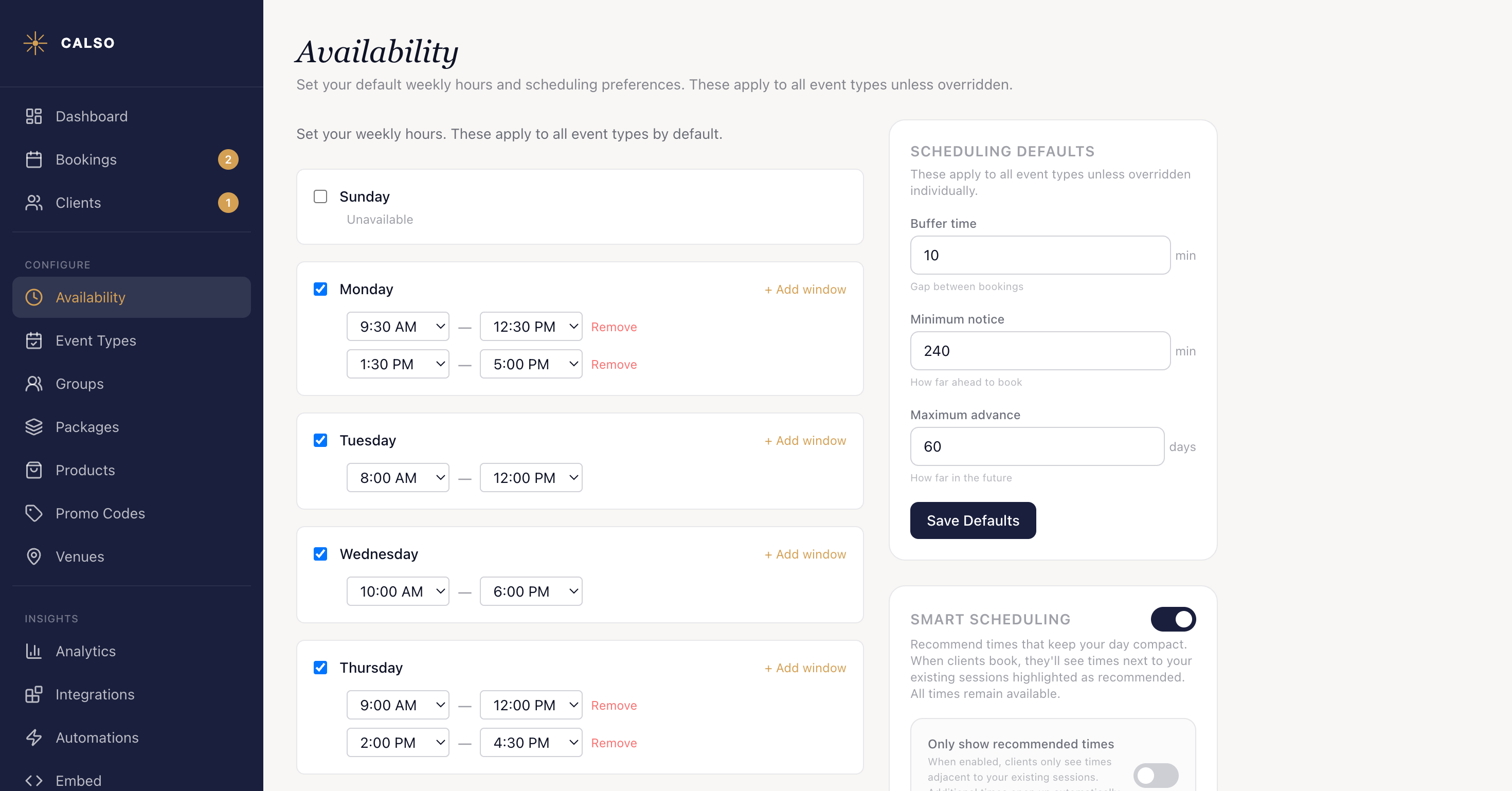 The Availability page: a card per weekday with Sunday reading Unavailable and Monday through Thursday ticked, Monday and Thursday each carrying two time windows split around the middle of the day, beside a Scheduling Defaults panel holding buffer time, minimum notice and maximum advance.